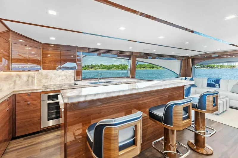 Team Harvey Yacht Photos Pics Luxurious interior of 2026 Viking 82 Convertible yacht with elegant wood finishes and scenic ocean view.