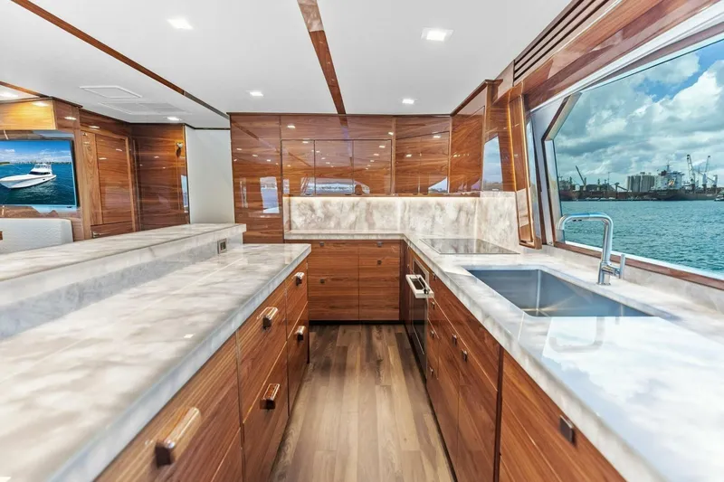Team Harvey Yacht Photos Pics Luxurious kitchen interior of 2026 Viking 82 Convertible yacht with ocean view.