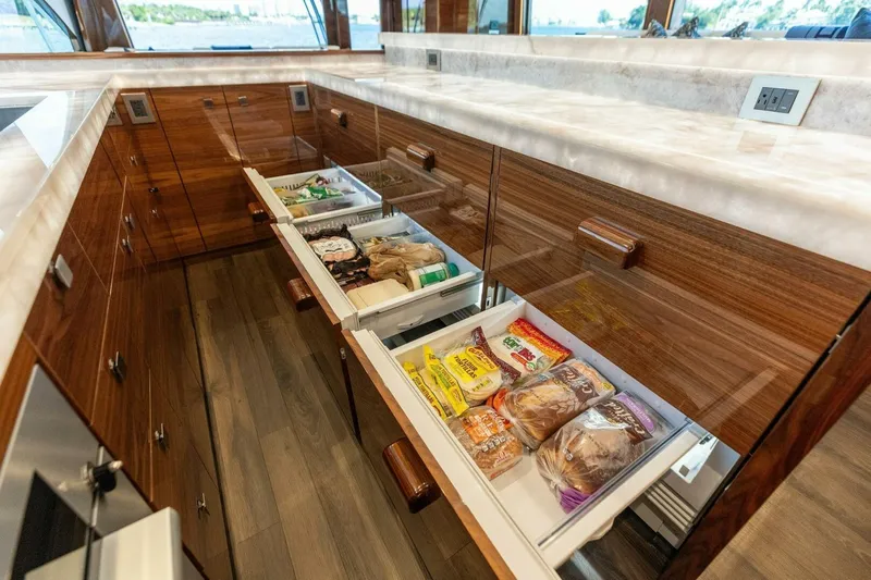 Team Harvey Yacht Photos Pics Luxurious kitchen drawers in 2026 Viking 82 Convertible yacht, showcasing organized food storage.
