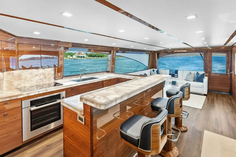 Team Harvey Yacht Photos Pics Luxurious interior of 2026 Viking 82 Convertible yacht with modern kitchen and ocean view.