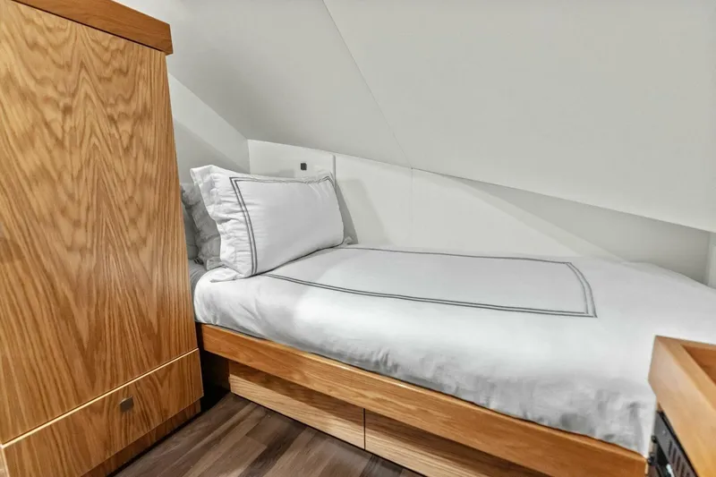Team Harvey Yacht Photos Pics Cozy cabin bed in 2026 Viking 82 Convertible yacht with wooden accents.