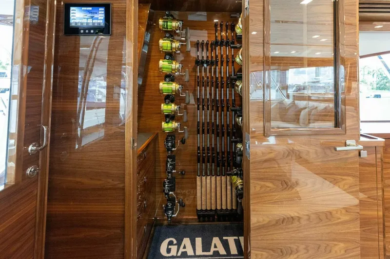 Team Harvey Yacht Photos Pics Luxurious 2026 Viking 82 Convertible yacht interior with fishing rods and wooden finish.