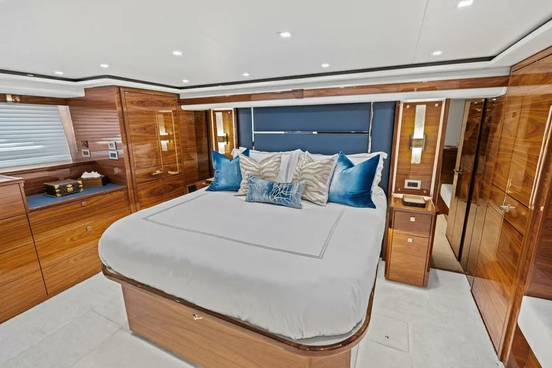 Team Harvey Yacht Photos Pics Luxurious bedroom interior of 2026 Viking 82 Convertible yacht with elegant wood finishes.