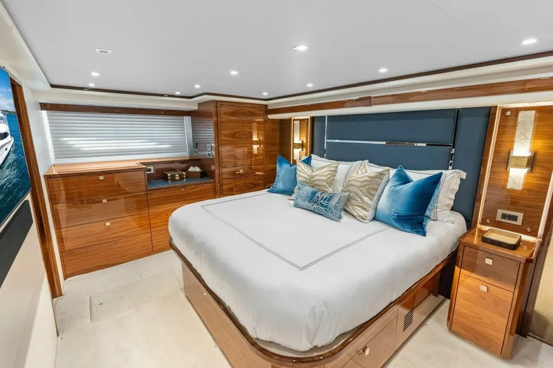 Team Harvey Yacht Photos Pics Luxurious bedroom interior of 2026 Viking 82 Convertible yacht with elegant wood finishes.