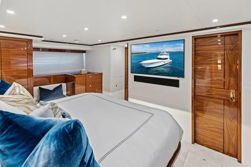 Team Harvey Yacht Photos Pics Luxurious 2026 Viking 82 Convertible yacht bedroom with elegant wood finishes and large TV.