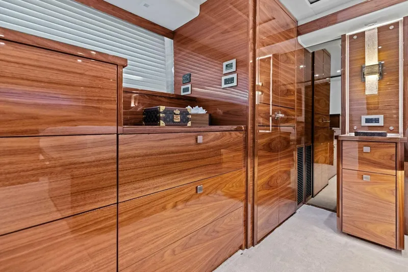Team Harvey Yacht Photos Pics Luxurious wood interior of 2026 Viking 82 Convertible yacht, featuring sleek cabinetry and modern design.