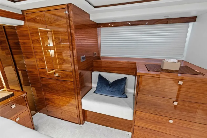 Team Harvey Yacht Photos Pics Luxurious wood interior of 2026 Viking 82 Convertible yacht with seating and storage.