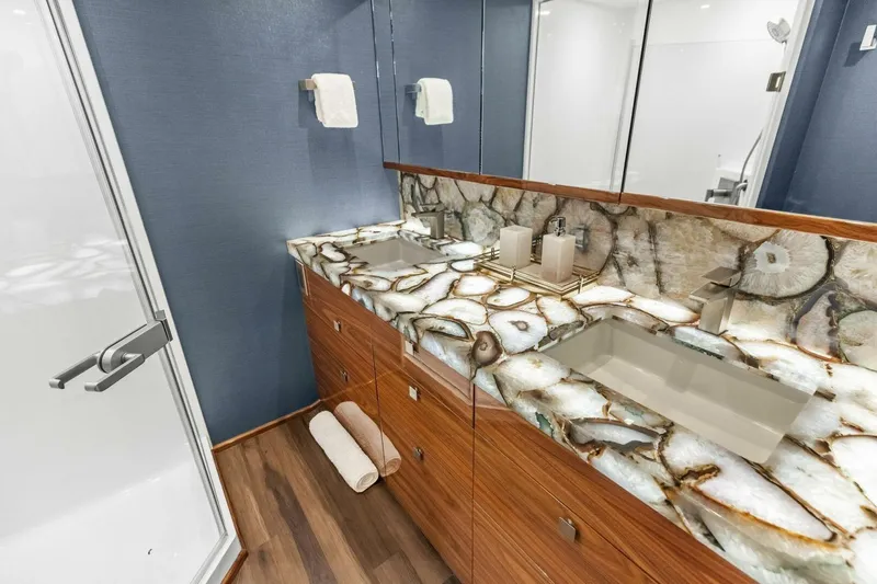Team Harvey Yacht Photos Pics Luxurious bathroom in 2026 Viking 82 Convertible yacht with elegant stone countertop.