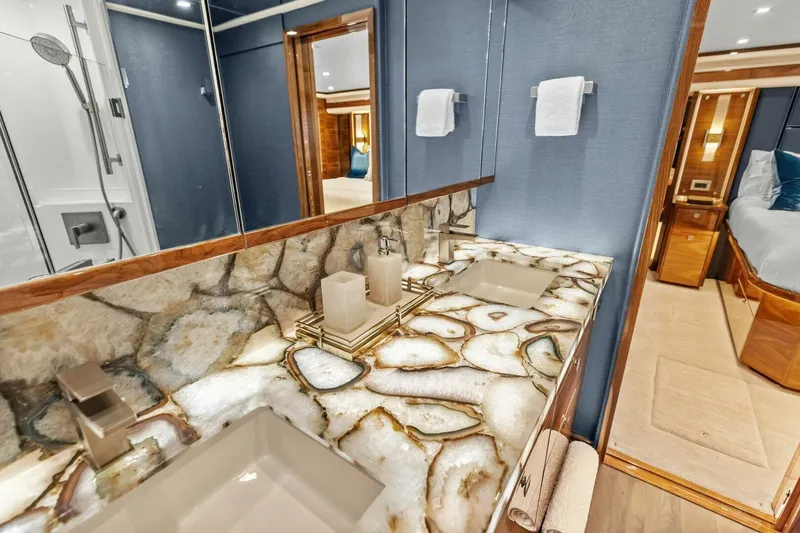 Team Harvey Yacht Photos Pics Luxurious bathroom in 2026 Viking 82 Convertible yacht with elegant stone countertop.