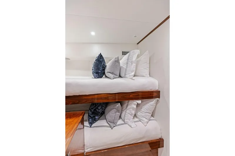 Team Harvey Yacht Photos Pics Luxurious bunk beds with plush pillows in 2026 Viking 82 Convertible yacht interior.
