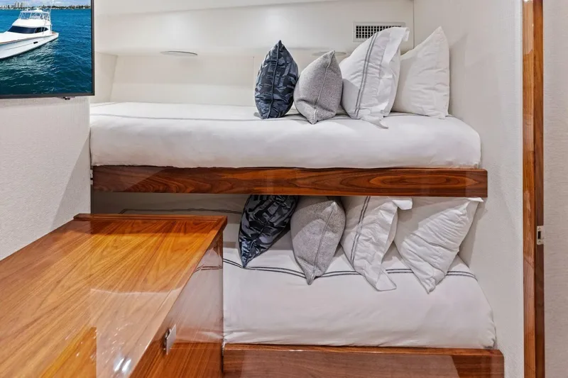 Team Harvey Yacht Photos Pics Interior of 2026 Viking 82 Convertible yacht with bunk beds and wooden finishes.
