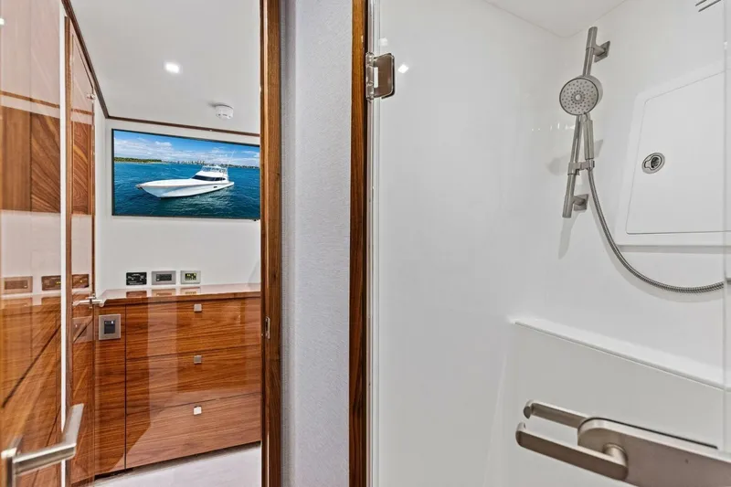 Team Harvey Yacht Photos Pics Luxurious interior of 2026 Viking 82 Convertible yacht with modern shower and wood accents.