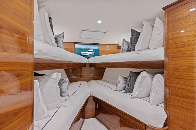 Team Harvey Yacht Photos Pics Luxurious cabin interior of 2026 Viking 82 Convertible yacht with wooden finish and plush bedding.