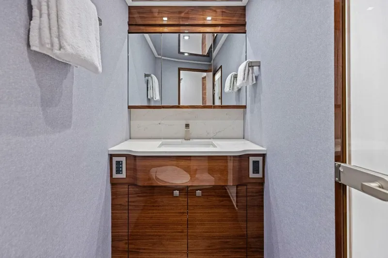 Team Harvey Yacht Photos Pics Luxurious bathroom in 2026 Viking 82 Convertible yacht with modern fixtures and elegant design.