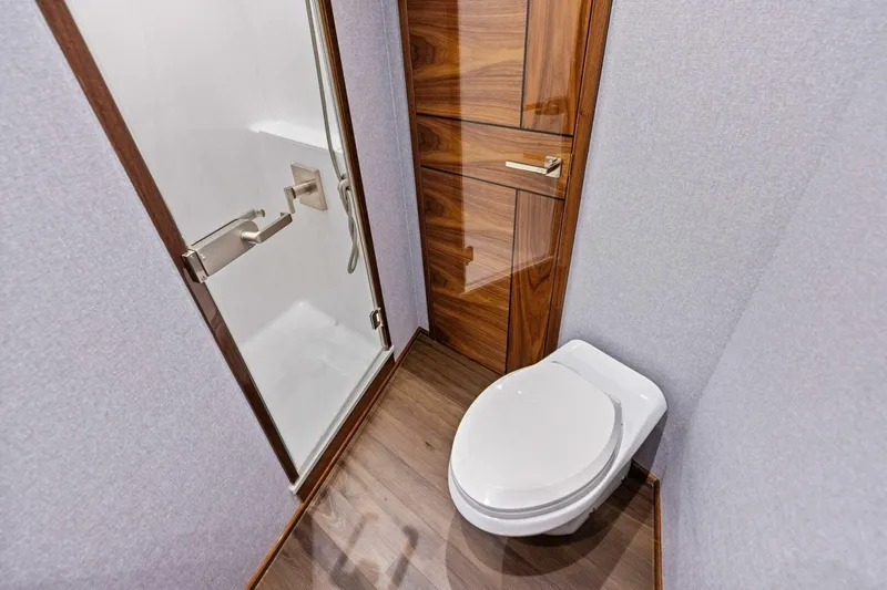Team Harvey Yacht Photos Pics Luxurious bathroom in 2026 Viking 82 Convertible yacht with modern shower and toilet.