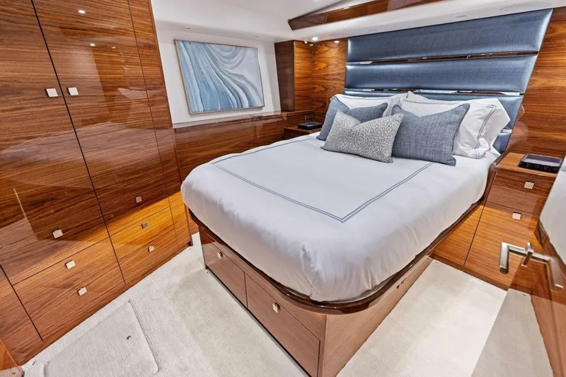 Team Harvey Yacht Photos Pics Luxurious bedroom interior of 2026 Viking 82 Convertible yacht with elegant wood finishes.