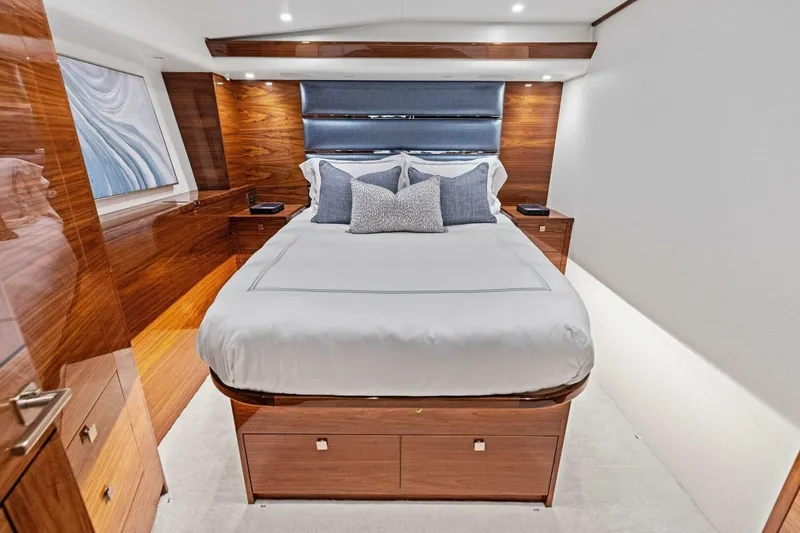 Team Harvey Yacht Photos Pics Luxurious bedroom interior of 2026 Viking 82 Convertible yacht with elegant wood finishes.