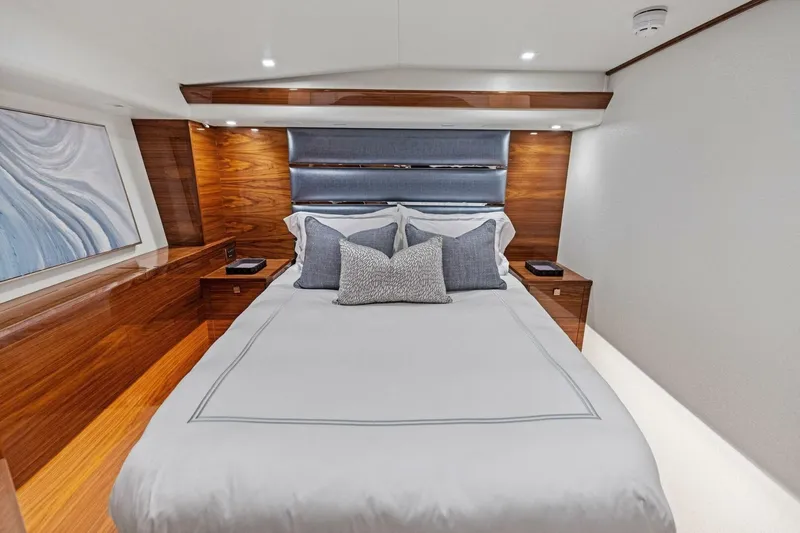 Team Harvey Yacht Photos Pics Luxurious bedroom interior of 2026 Viking 82 Convertible yacht with elegant wood finishes.