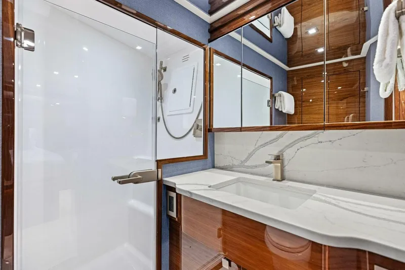 Team Harvey Yacht Photos Pics Luxurious bathroom in 2026 Viking 82 Convertible yacht with marble countertop and modern fixtures.