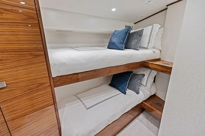 Team Harvey Yacht Photos Pics Luxurious bunk beds in 2026 Viking 82 Convertible yacht cabin, featuring elegant wood finish.