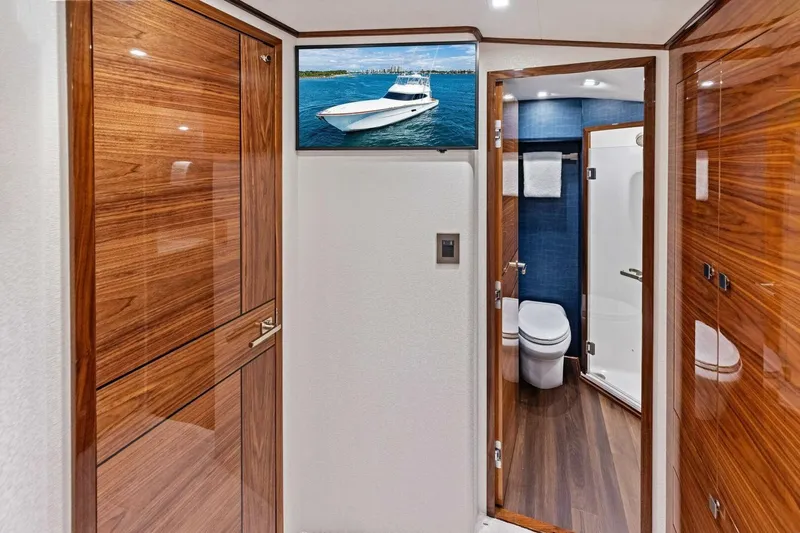Team Harvey Yacht Photos Pics Luxurious interior of 2026 Viking 82 Convertible yacht with wood finishes and modern bathroom.