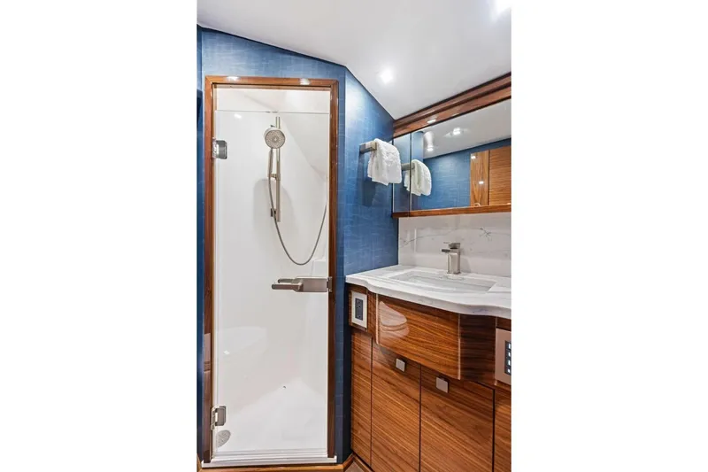 Team Harvey Yacht Photos Pics Luxurious bathroom in 2026 Viking 82 Convertible yacht with modern shower and elegant wood finishes.