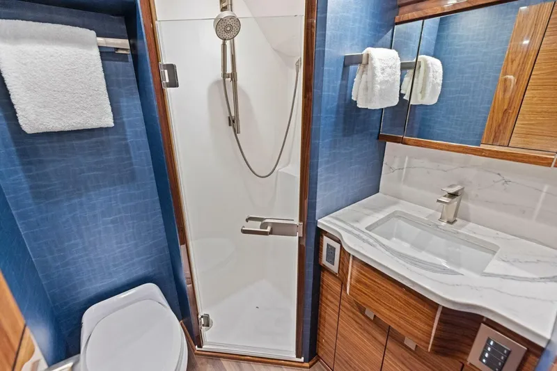 Team Harvey Yacht Photos Pics Luxurious bathroom in 2026 Viking 82 Convertible yacht with modern fixtures and elegant design.