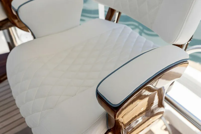 Team Harvey Yacht Photos Pics Luxurious white seating on 2026 Viking 82 Convertible yacht, featuring elegant wood accents.