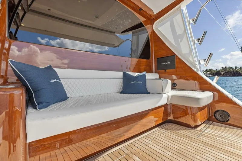 Team Harvey Yacht Photos Pics Luxurious seating area on 2026 Viking 82 Convertible yacht with elegant wood finish.
