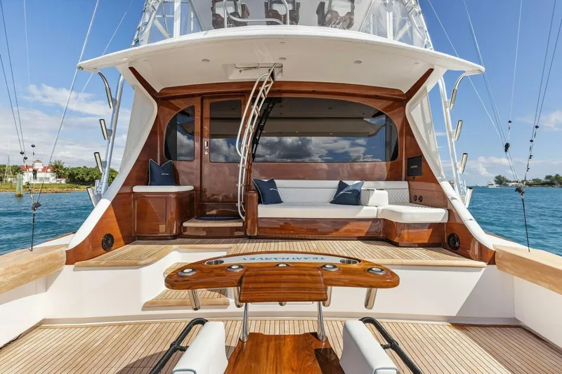 Team Harvey Yacht Photos Pics Luxurious 2026 Viking 82 Convertible yacht with elegant wooden deck and seating area.