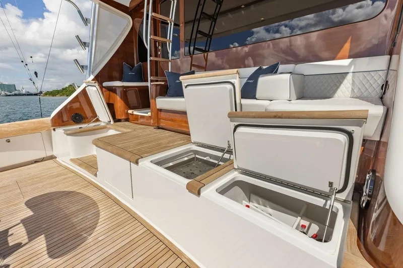Team Harvey Yacht Photos Pics Luxury deck of 2026 Viking 82 Convertible yacht with seating and storage compartments.