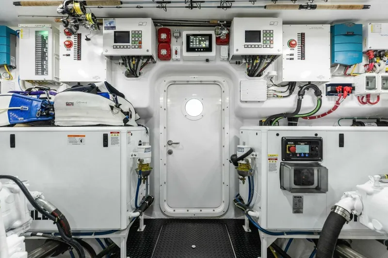 Team Harvey Yacht Photos Pics Engine room of 2026 Viking 82 Convertible yacht, featuring control panels and equipment.