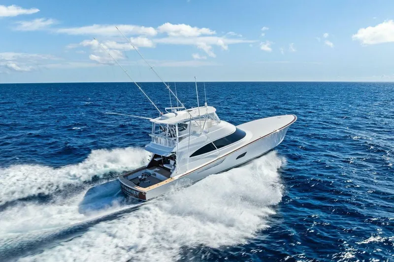 Team Harvey Yacht Photos Pics 2026 Viking 82 Convertible yacht cruising on open ocean under clear blue sky.