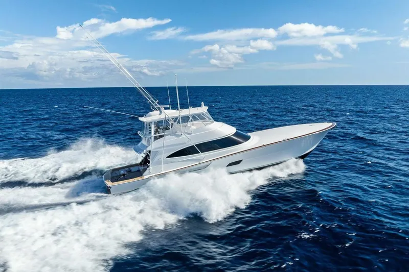 Team Harvey Yacht Photos Pics 2026 Viking 82 Convertible yacht cruising on open ocean under clear blue sky.