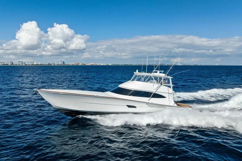 Team Harvey Yacht Photos Pics 2026 Viking 82 Convertible yacht cruising on open ocean under clear blue sky.