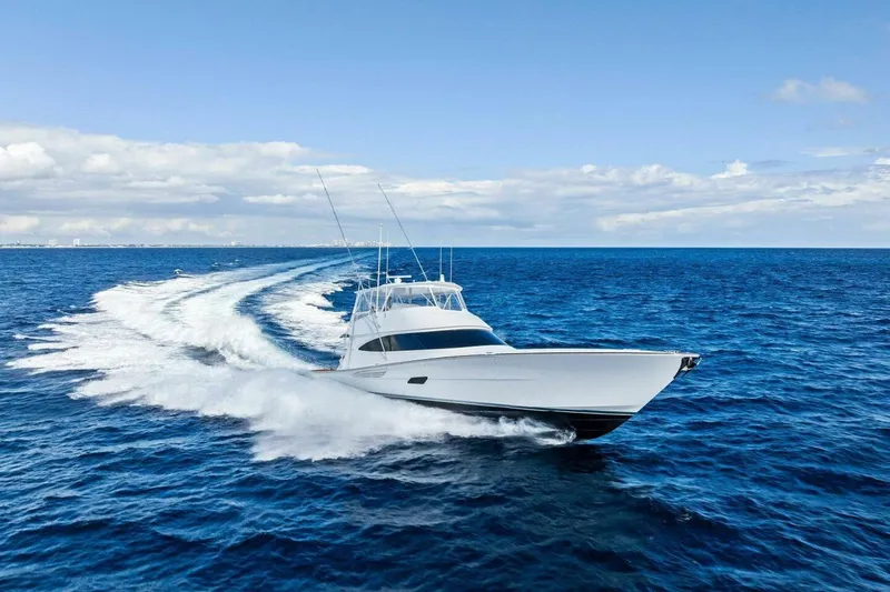 Team Harvey Yacht Photos Pics 2026 Viking 82 Convertible yacht cruising on open ocean under clear skies.