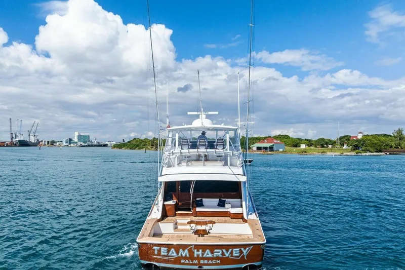 Team Harvey Yacht Photos Pics Viking 82 Convertible 2026 yacht cruising near Palm Beach under a clear blue sky.