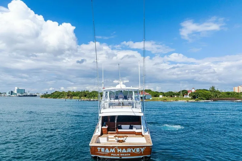 Team Harvey Yacht Photos Pics 2026 Viking 82 Convertible yacht on water, clear sky, "Team Harvey" on stern.