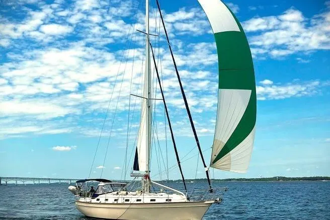 Epithelios Yacht Photos Pics 2002 Island Packet 420 sailboat with green and white spinnaker on open water.