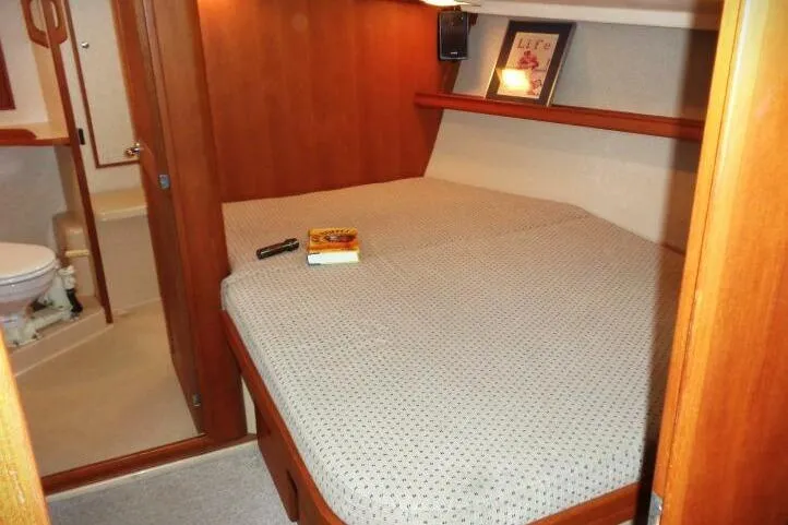 Epithelios Yacht Photos Pics Cozy cabin interior of 2002 Island Packet 420 sailboat with bed and bathroom.