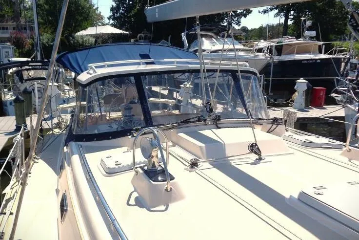 Epithelios Yacht Photos Pics 2002 Island Packet 420 sailboat docked at marina, featuring spacious deck and blue canopy.