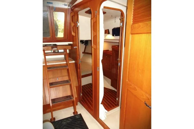 Epithelios Yacht Photos Pics Interior of 2002 Island Packet 420 sailboat with wooden cabinetry and cozy cabin space.