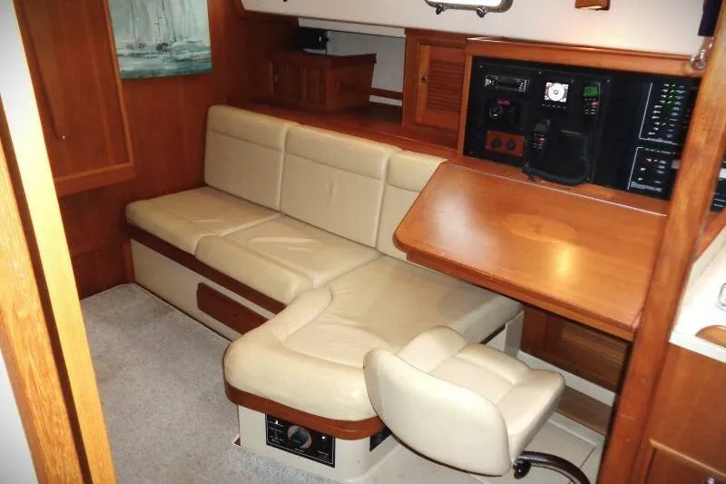 Epithelios Yacht Photos Pics Interior of 2002 Island Packet 420 yacht with beige seating and navigation station.