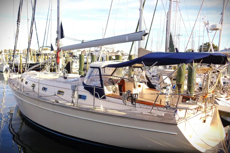 Epithelios Yacht Photos Pics 2002 Island Packet 420 sailboat docked at marina, featuring blue canopy and sleek design.