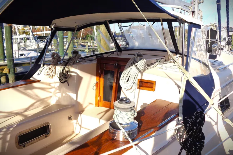 Epithelios Yacht Photos Pics 2002 Island Packet 420 sailboat cockpit with ropes and winch, docked at marina.