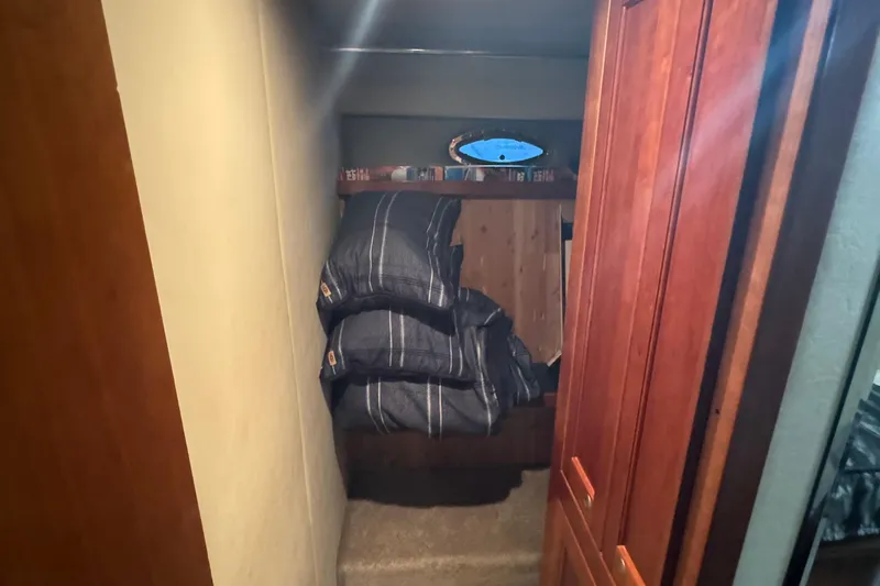  Yacht Photos Pics 2006 Cruisers Yachts 560 Express cabin interior with bed and wooden cabinetry.