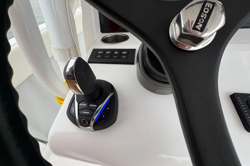Changes In Lattitudes Yacht Photos Pics Control panel of 2023 Jupiter 30 boat with joystick and steering wheel.