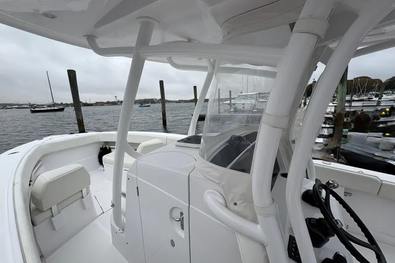Changes In Lattitudes Yacht Photos Pics 2023 Jupiter 30 boat interior with white seating, docked at a marina.
