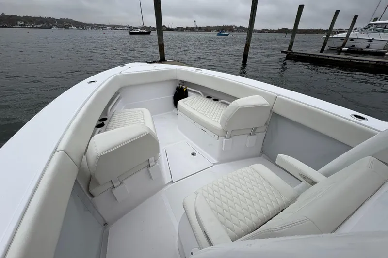 Changes In Lattitudes Yacht Photos Pics 2023 Jupiter 30 boat interior with white seating, docked by the water.