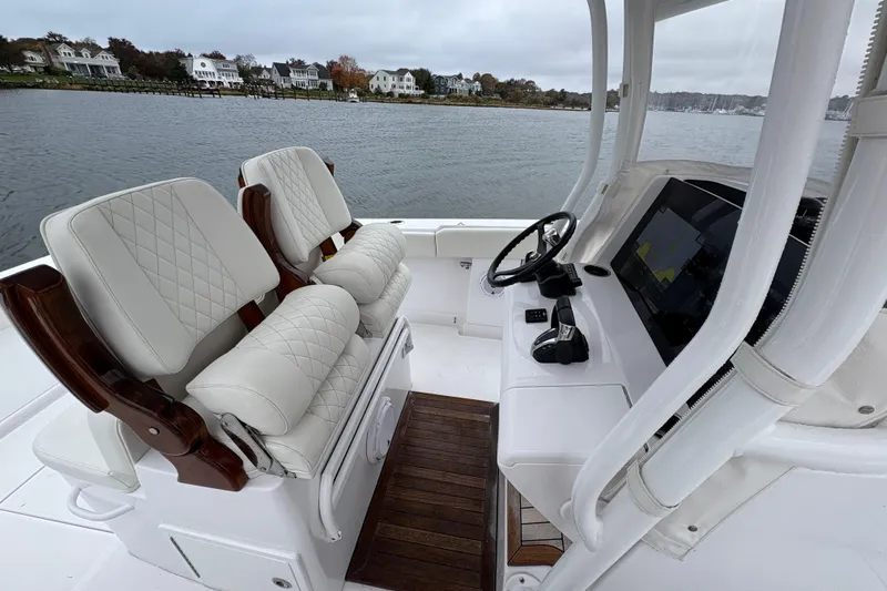 Changes In Lattitudes Yacht Photos Pics Luxurious 2023 Jupiter 30 boat interior with plush seating and advanced navigation system.